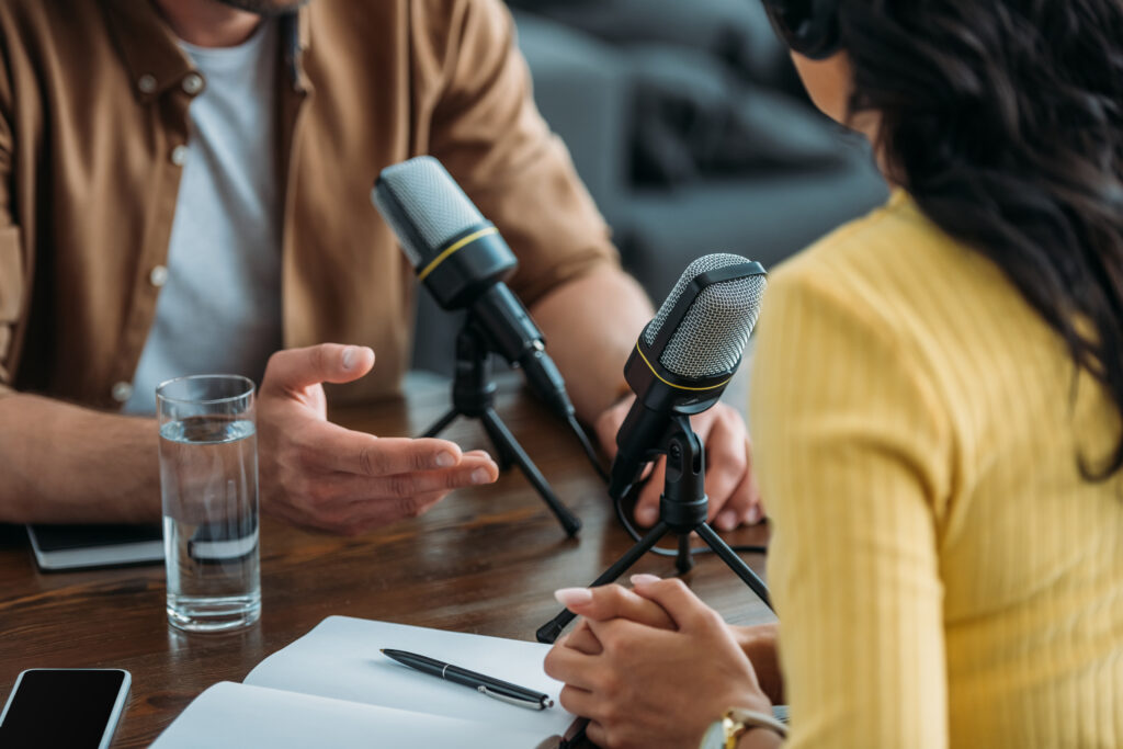 podcast hosts with mics