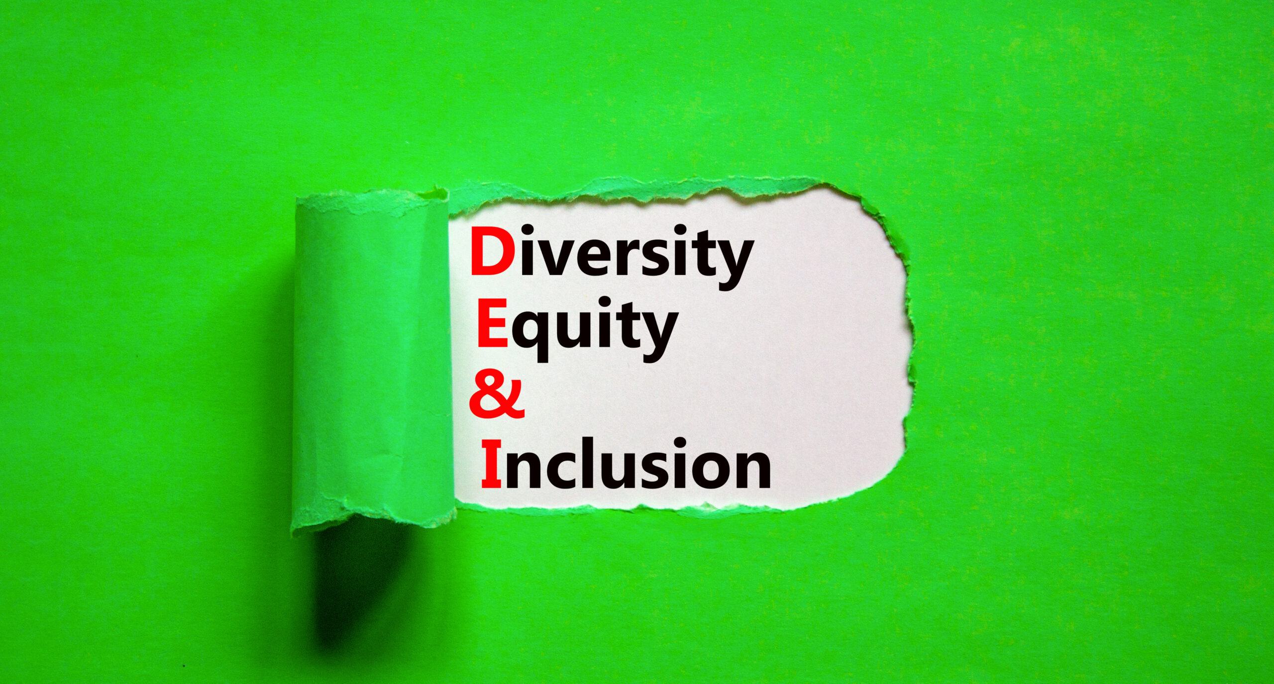 Torn page with the words Diversity Equity & Inclusion representing DEI and the importance of fostering a positive work culture