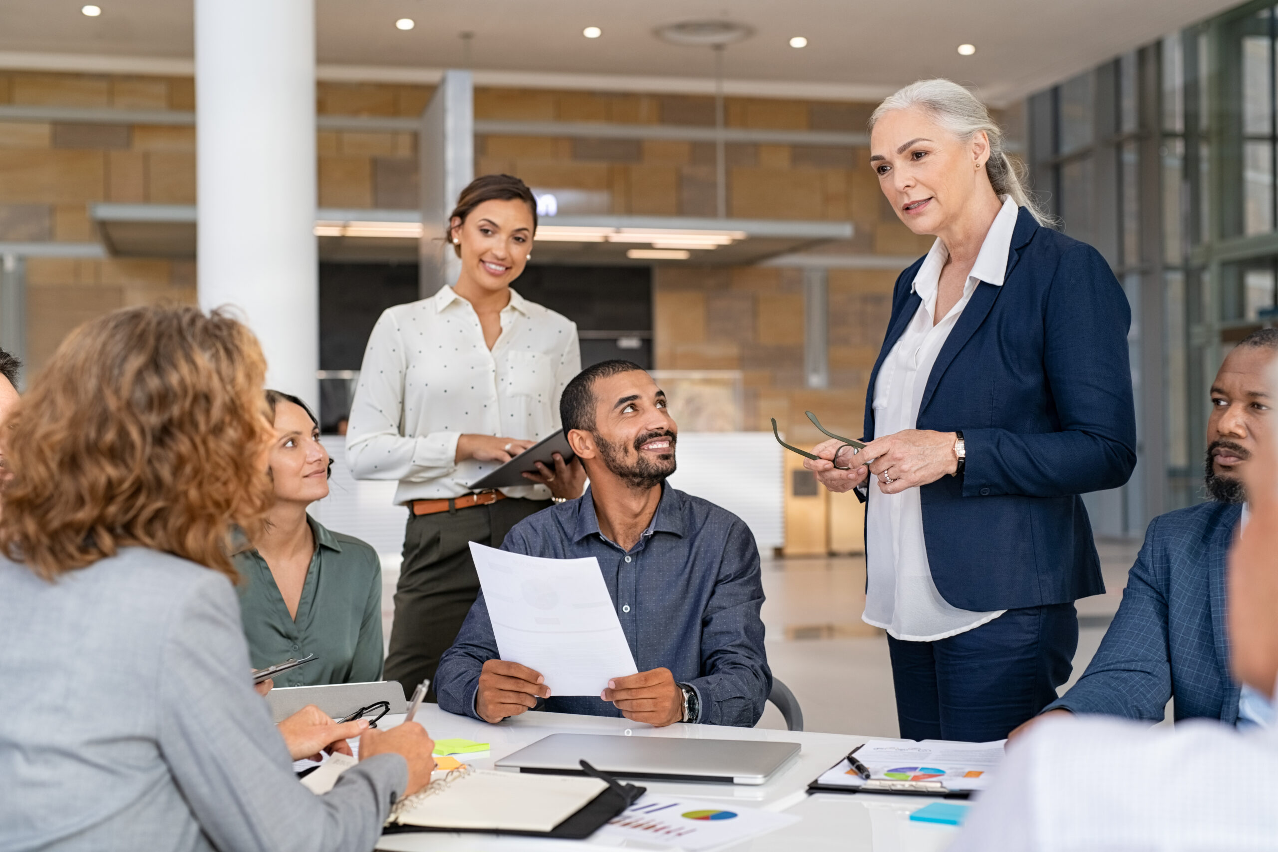 Group of mixed race business people discussing and communicating strategies and ideas